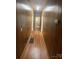 Wood paneled hallway with hardwood floors connecting various areas of the house at 818 N 4Th St, Albemarle, NC 28001