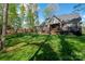Brick home featuring a large backyard with a covered patio and an outdoor seating area at 8209 Bella Vista Ct, Charlotte, NC 28216