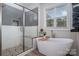 Bright bathroom with a soaking tub and a separate glass-enclosed shower at 8209 Bella Vista Ct, Charlotte, NC 28216