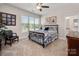 This bedroom includes a queen size bed, a black leather chair and a window with view of the manicured yard at 8209 Bella Vista Ct, Charlotte, NC 28216