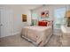 This bedroom features plush carpeting, a queen size bed with luxury bedding and is illuminated by two windows at 8209 Bella Vista Ct, Charlotte, NC 28216