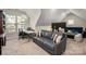 Bonus room offers a sleeper sofa, desk, and a window with a beautiful green backyard view at 8209 Bella Vista Ct, Charlotte, NC 28216