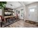 Bright dining area with a wooden table, leather chairs, floral rug, and a stylish bar cabinet at 8209 Bella Vista Ct, Charlotte, NC 28216