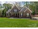 Beautiful two-story brick home with a manicured lawn and inviting front porch at 8209 Bella Vista Ct, Charlotte, NC 28216