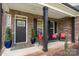 Charming covered porch with seating area, brick columns, and welcoming decor at 8209 Bella Vista Ct, Charlotte, NC 28216