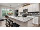 Modern kitchen featuring granite countertops, white cabinets, and stainless steel appliances, great for cooking at 8209 Bella Vista Ct, Charlotte, NC 28216