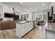 Bright kitchen featuring an island with granite countertops, stainless steel appliances, and hardwood floors at 8209 Bella Vista Ct, Charlotte, NC 28216