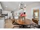 Bright eat-in kitchen with stainless steel appliances, access to living room, and copper-colored dining table at 8209 Bella Vista Ct, Charlotte, NC 28216