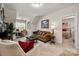 Spacious living room with comfortable couches, a large window, and an office space behind the couch at 8209 Bella Vista Ct, Charlotte, NC 28216