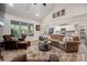 Living room flows into kitchen featuring plush seating, decorative rug, and bright natural light at 8209 Bella Vista Ct, Charlotte, NC 28216