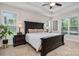 Main bedroom features a tray ceiling, a large bed with side tables, and natural light from multiple windows at 8209 Bella Vista Ct, Charlotte, NC 28216