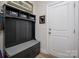 Well-organized mudroom with storage hooks, benches, and baskets for convenient entryway at 8209 Bella Vista Ct, Charlotte, NC 28216