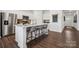 Modern kitchen with center island, barstool seating, stainless steel appliances, and sleek white cabinetry at 825 Hallman Branch Ln, Lincolnton, NC 28092