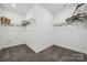 Spacious walk-in closet with carpet flooring and built in shelving and hanging racks at 825 Hallman Branch Ln, Lincolnton, NC 28092