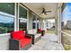 Cozy screened porch with ceiling fan and comfortable wicker furniture for outdoor entertaining and relaxation at 8718 Festival Way, Charlotte, NC 28215
