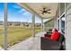 Open screened porch with ceiling fan providing relaxing view of the lawn and neighborhood at 8718 Festival Way, Charlotte, NC 28215