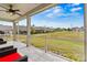 Relaxing screened porch with ceiling fan overlooking landscaped backyard and view of the neighborhood green space at 8718 Festival Way, Charlotte, NC 28215