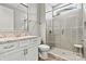 Well-lit bathroom with a glass shower, and a white vanity with a granite countertop at 8718 Festival Way, Charlotte, NC 28215