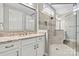 This bathroom showcases a glass shower, and a white vanity with a granite countertop at 8718 Festival Way, Charlotte, NC 28215