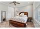 This bedroom features hard wood floors and neutral decor with large windows for ample light at 8718 Festival Way, Charlotte, NC 28215