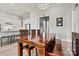 Dining room with wood floors, wood table and chairs, and modern light fixture at 8718 Festival Way, Charlotte, NC 28215