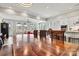 Large wood dining table with seating surrounded by natural light from surrounding windows at 8718 Festival Way, Charlotte, NC 28215