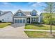Charming home with blue siding, stone accents, and a well-manicured lawn at 8718 Festival Way, Charlotte, NC 28215