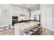 Eat-in kitchen with granite counters, stainless appliances, and center island with breakfast bar at 8718 Festival Way, Charlotte, NC 28215