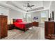 Primary bedroom with wood floors, tray ceiling, and large windows at 8718 Festival Way, Charlotte, NC 28215