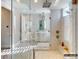 Bright bathroom featuring a glass enclosed shower with rainfall shower head, and a white vanity at 8805 Wingard Dr, Waxhaw, NC 28173