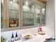 Butler's pantry with marble countertops, glass-front cabinets, wine cooler and accessories at 8805 Wingard Dr, Waxhaw, NC 28173
