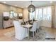 Dining room with wainscotting, hardwood flooring, area rug, and a decorative light fixture at 8805 Wingard Dr, Waxhaw, NC 28173