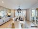 Dining room featuring wainscotting, hardwood flooring, area rug, and sliding glass doors to a patio at 8805 Wingard Dr, Waxhaw, NC 28173