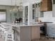 Stylish kitchen featuring an oversized island with seating, custom cabinetry, and stainless steel appliances at 8805 Wingard Dr, Waxhaw, NC 28173
