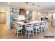 Spacious open kitchen featuring a large island, modern pendant lighting, and hardwood flooring at 8805 Wingard Dr, Waxhaw, NC 28173