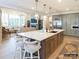 Open concept kitchen with a large island, stainless steel appliances, and modern pendant lighting at 8805 Wingard Dr, Waxhaw, NC 28173
