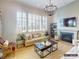 Stylish living room with a fireplace, a modern light fixture, and bright natural light at 8805 Wingard Dr, Waxhaw, NC 28173