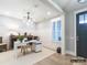 Bright home office with wainscotting, white desk, neutral decor, and natural light at 8805 Wingard Dr, Waxhaw, NC 28173