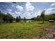 Peaceful pond view showcasing lush grass and vegetation; a scenic and tranquil setting at 8805 Wingard Dr, Waxhaw, NC 28173