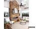 Cozy sunroom with a stone fireplace, large windows, and comfortable seating at 8805 Wingard Dr, Waxhaw, NC 28173