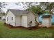 Exterior view of the backyard featuring a quaint storage shed, green lawn, and a well-maintained home at 904 Brook St, Belmont, NC 28012
