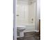 Bathroom featuring an all-white shower and toilet with wood vanity and dark wood laminate flooring at 904 Brook St, Belmont, NC 28012