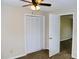 Bedroom featuring carpet, ceiling fan, and closet; neutral walls throughout the bedroom at 904 Brook St, Belmont, NC 28012