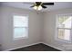 Cozy bedroom featuring two windows for natural light, carpet, and a ceiling fan, creating a relaxing retreat at 904 Brook St, Belmont, NC 28012