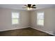 Bedroom with carpet, neutral walls, two windows, and a ceiling fan; a clean and comfortable space at 904 Brook St, Belmont, NC 28012