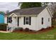 Attractive single-story home showcasing a well-maintained lawn, updated windows, and crisp, clean white siding and black shutters at 904 Brook St, Belmont, NC 28012