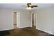 Cozy living room featuring carpet, a ceiling fan, neutral walls, and a view of other rooms at 904 Brook St, Belmont, NC 28012