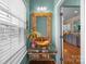 Stylish bathroom with glass vanity, unique mirror, and view to the kitchen at 10308 Garrett Grigg Rd, Charlotte, NC 28262