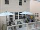 Cozy deck with stylish seating, shade umbrellas and a fire pit for outdoor relaxation at 10308 Garrett Grigg Rd, Charlotte, NC 28262