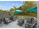 Relax on this cozy deck with modern outdoor furniture and a tranquil wooded backdrop at 10308 Garrett Grigg Rd, Charlotte, NC 28262